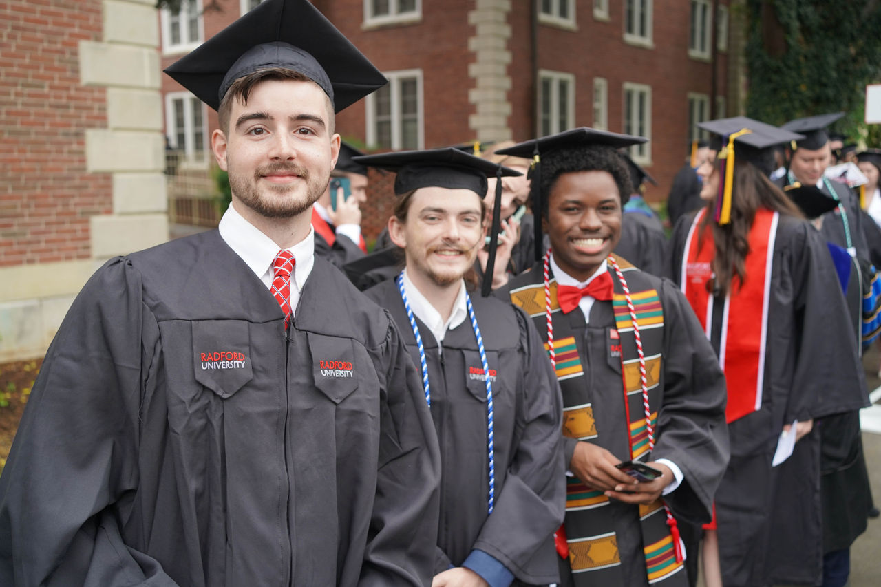 Students line up with caps and gowns at graduation with the text "Employment opportunities after graduation"